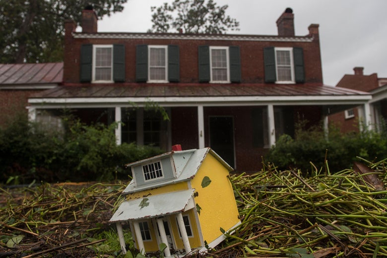 A toy house and other debris is strewn in the front lawn of a house, from flooding the day before when Hurricane Florence made landfal, in New Bern, North Carolina on September 15, 2018.
